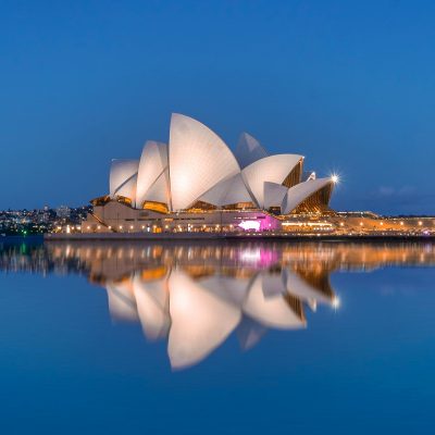 Beautiful view of the Sydney Opera House and its reflection at dusk, highlighting iconic architecture.