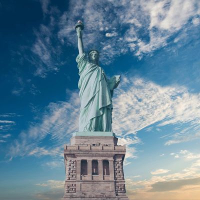 Iconic Statue of Liberty with a backdrop of a vibrant blue sky, symbolizing freedom and America.